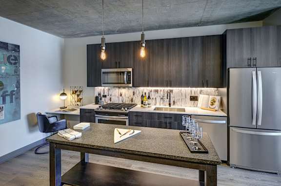 A modern kitchen with a dining table and chairs. at The Mason Apartments, Chicago, IL