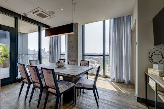 A modern dining room with a table set for four. at The Mason Apartments, Illinois