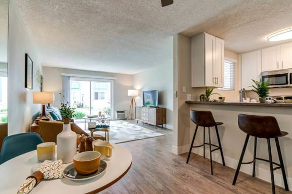a living room and kitchen with a table and chairs  at Veranda La Mesa, La Mesa, 91942