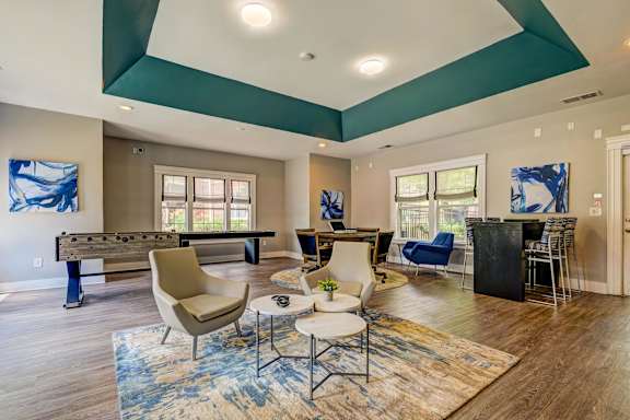 Clubhouse game room with pool table and bar seating at Wyndchase Aspen Grove Apartments, Franklin