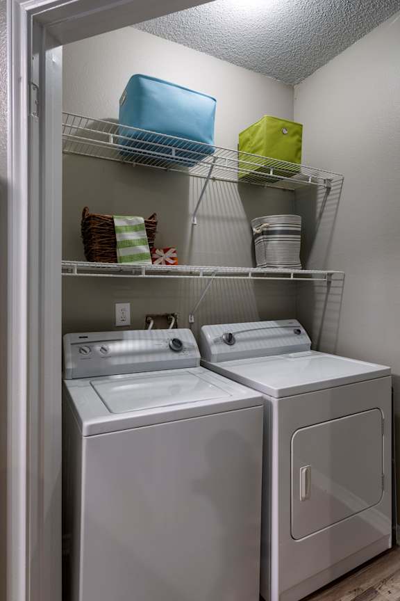 In unit laundry closet with stacked storage shelves at Wyndchase Aspen Grove Apartments, Franklin, TN