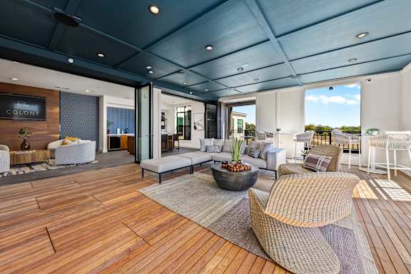 A modern living room with a wooden floor and a large window.