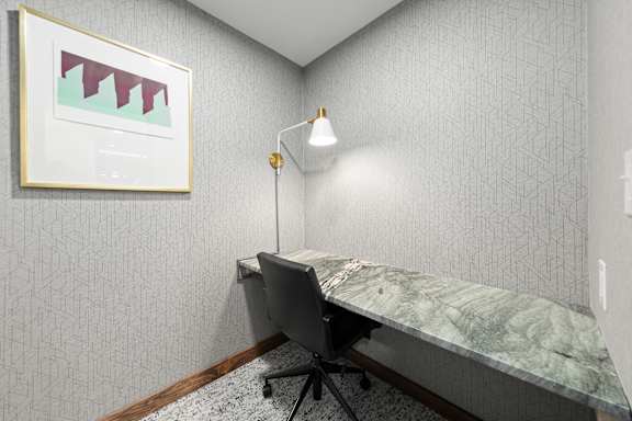 A room with a desk and a chair.