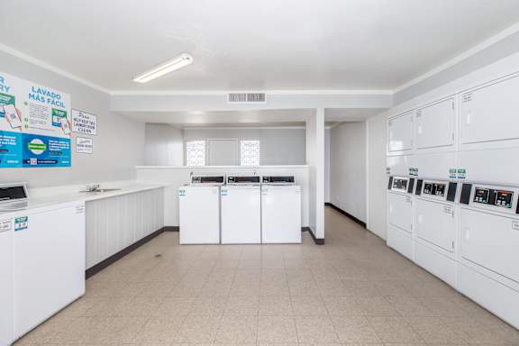 Laundry room with washers and dryers.