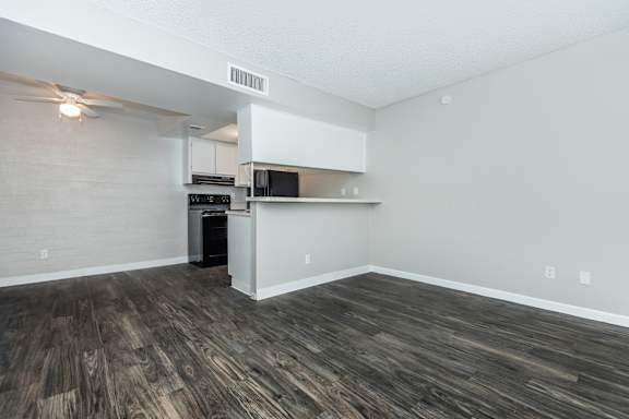 A kitchen area with a microwave and oven built into the cabinetry.