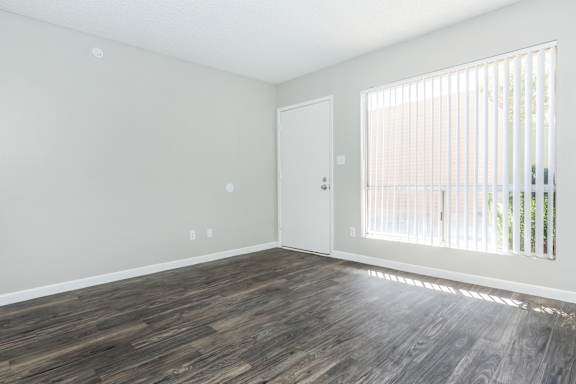 A room with a wooden floor and a door.