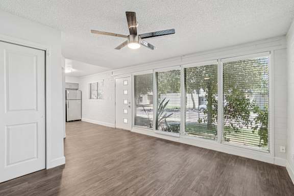 A room with a ceiling fan and sliding glass doors at Palm Villas Apartments, Arizona, 85257