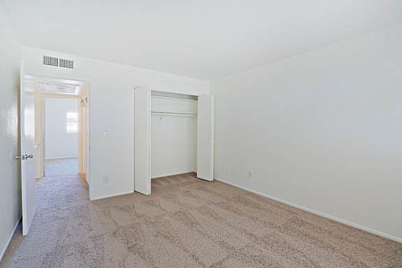 A room with carpeted floor and white walls.