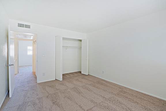 A room with carpeted floor and white walls.