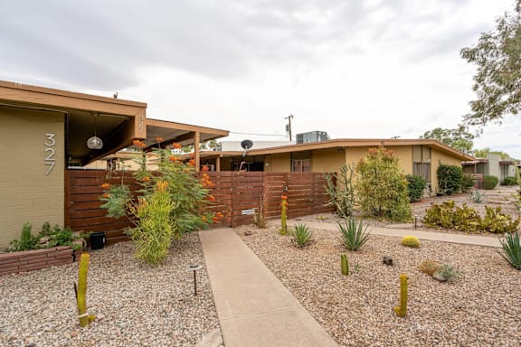 A house with a gravel front yard and a concrete walkway.