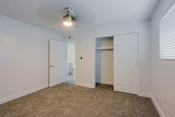 A room with a carpeted floor and a ceiling fan at Palm Villas Apartments, Scottsdale, 85257