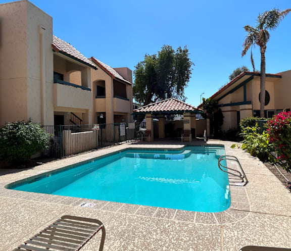 A pool in a courtyard surrounded by buildings.