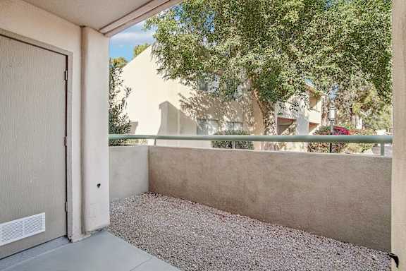 A view of a courtyard with a closed door. at The Viridian Apartments, Arizona