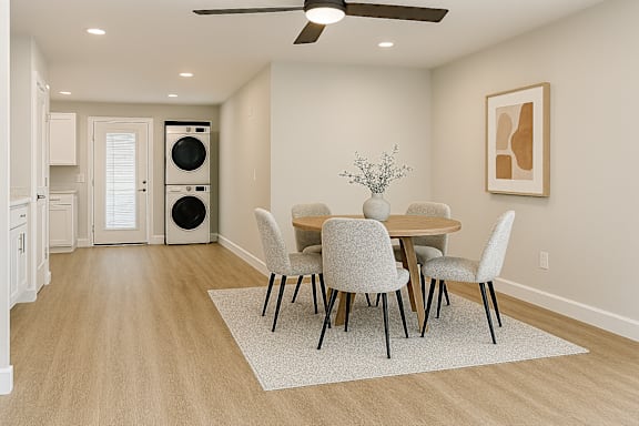A dining room with a table set for four.