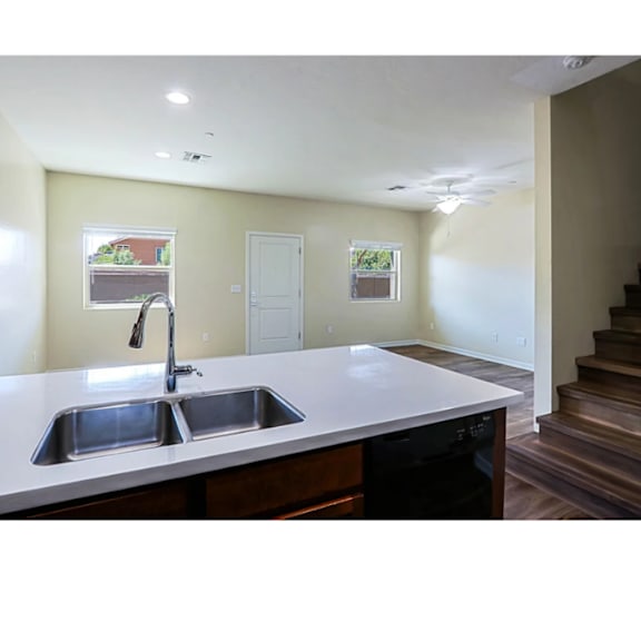 A kitchen with a sink and a window.