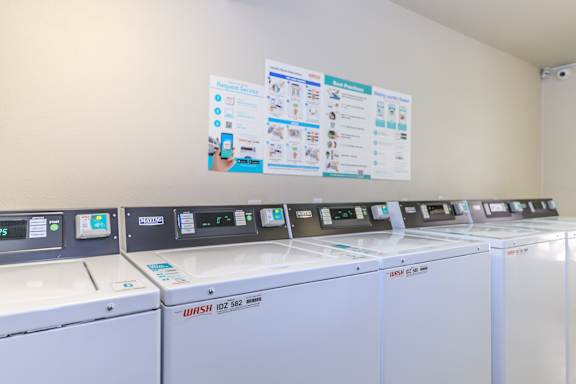 A series of Wash machines are lined up in a row.