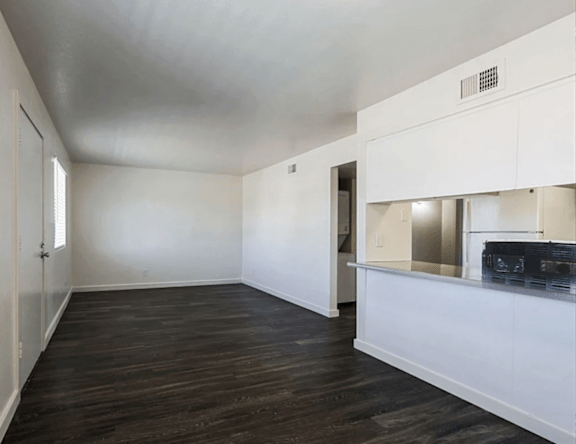 A room with white walls and a wooden floor.