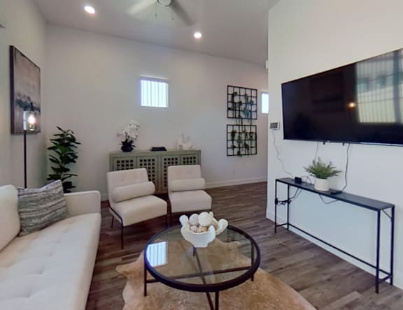 Furnished apartment living area shown — representative home at Allero 59.