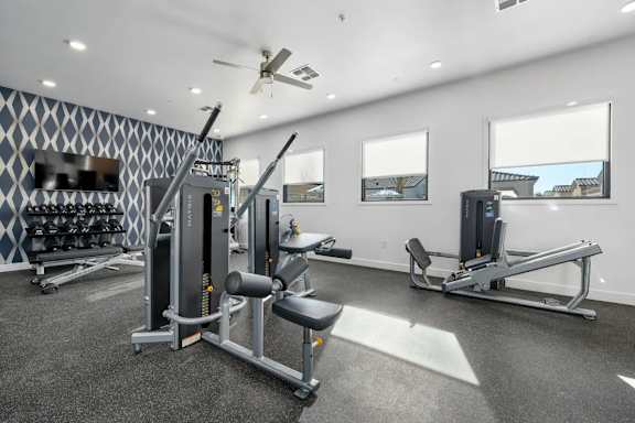 A well-equipped gym with a variety of machines and weightlifting equipment.