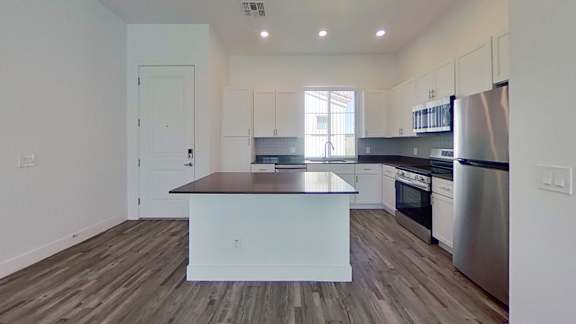 A kitchen with a wooden island in the middle of it.