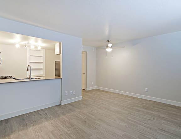 A room with a wooden floor and white walls.