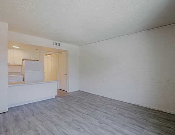 A room with a white wall and a grey floor.