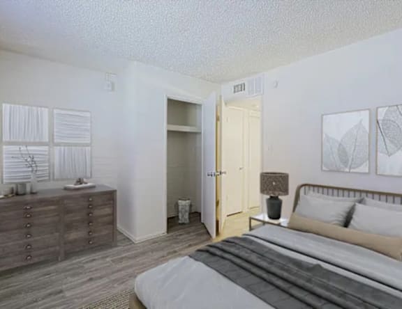 A bedroom with a bed, dresser, and nightstand.