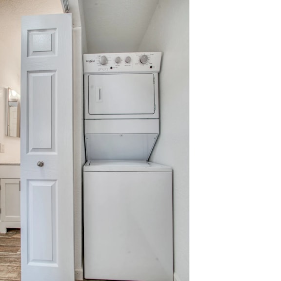 A white washing machine and dryer in a small room.