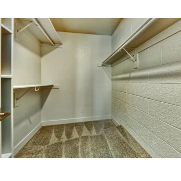 A small, empty room with a carpeted floor and white walls.