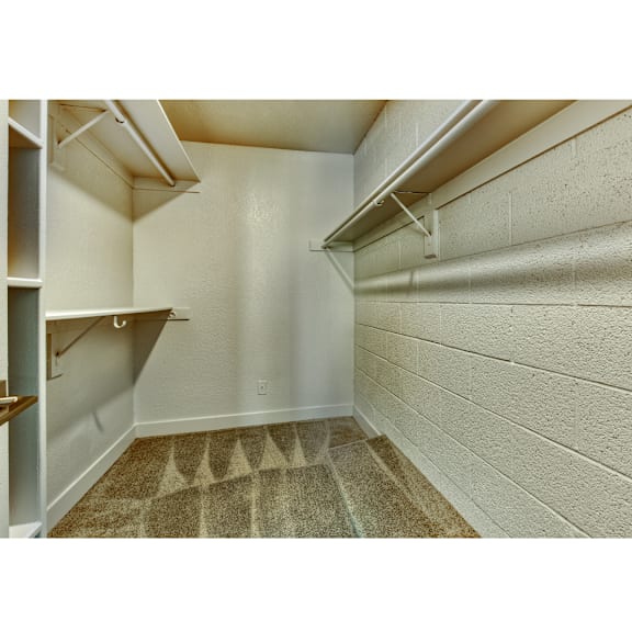 A small, empty room with a carpeted floor and white walls.