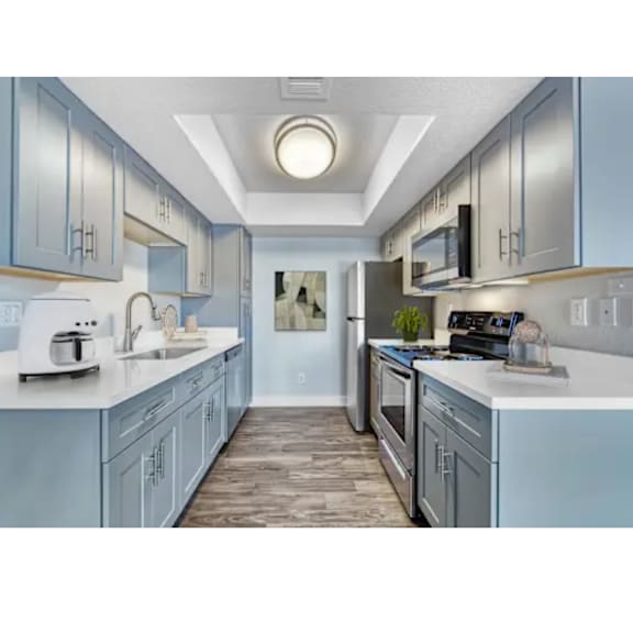 A kitchen with a white toaster and sink.