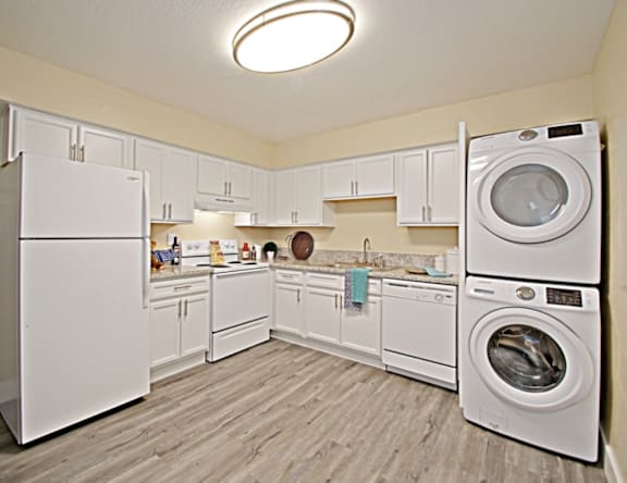 A white laundry room with a washer and dryer.