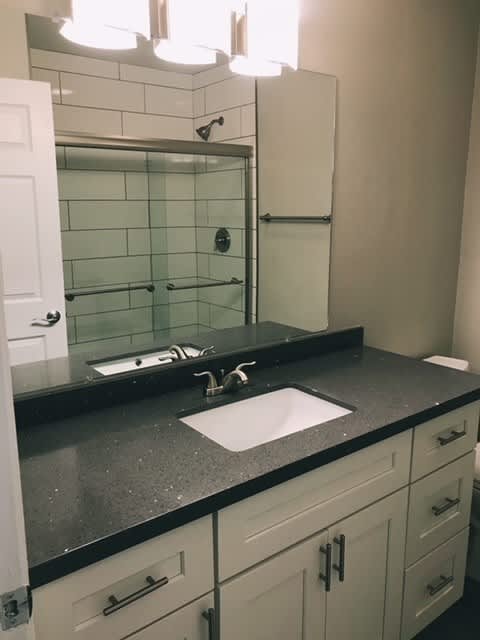A bathroom with a sink and a mirror.