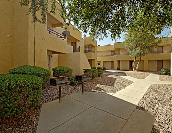 Apartment complex with a small garden in front.