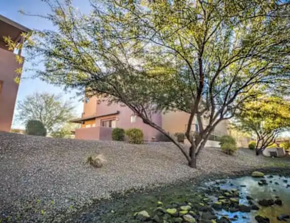 A house with a tree in front of it.