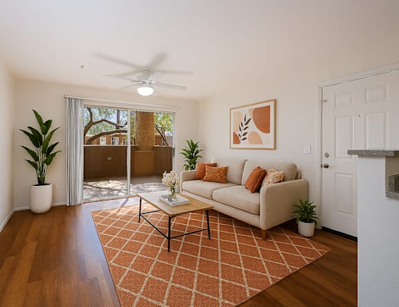 A living room with a couch, a coffee table, and a rug.