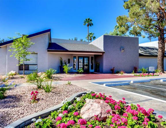 A house with a front yard and a driveway.