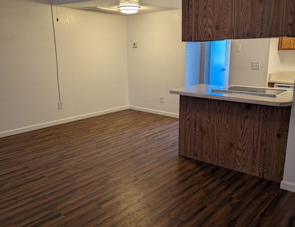 A room with wooden floors and a white wall.