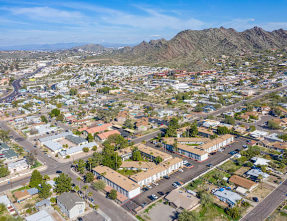 A bird's eye view of a residential area with houses and roads.