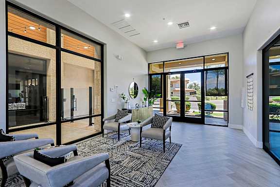 A modern living room with a glass door leading to a balcony.