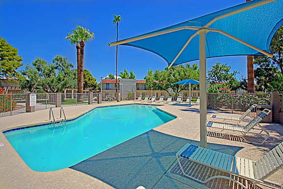 A blue pool with a blue umbrella.
