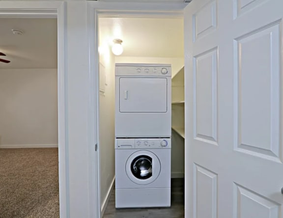 A white washing machine and dryer in a small laundry room.