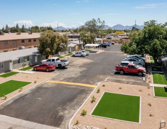 A parking lot with cars and a building in the background.