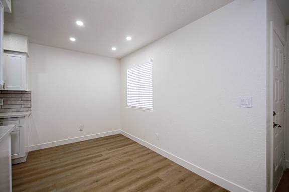 A room with wooden floors and white walls.