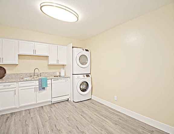 A laundry room with a washer and dryer stacked on top of each other.