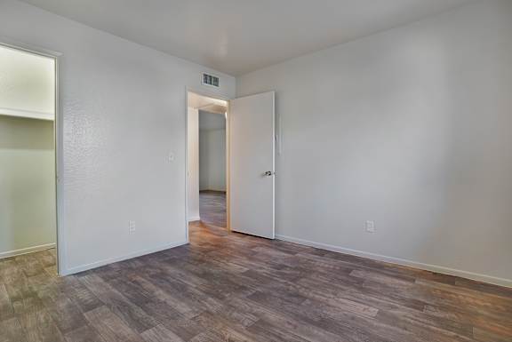 A room with a wooden floor and white walls.