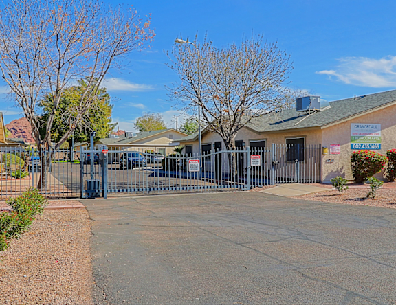A gated entrance to a building with a sign that reads "CAMERA GARAGE".