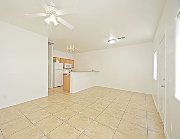 A room with a fan and a tile floor.