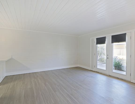 A room with a white ceiling and a wooden floor.