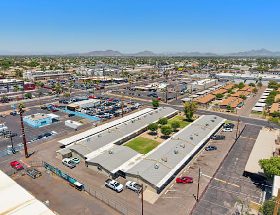 A parking lot with cars and buildings in the background.
